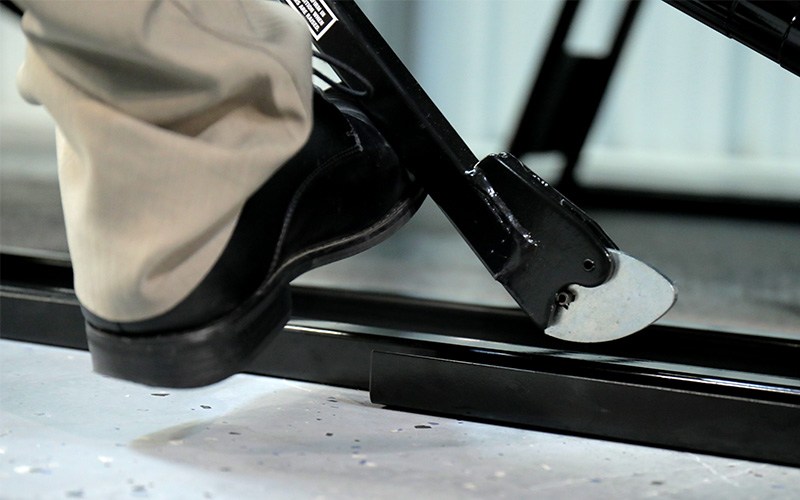 Release QuickJack safety locks to lower