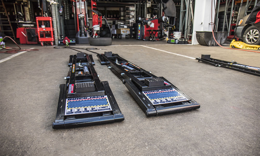 Release QuickJack safety locks to lower